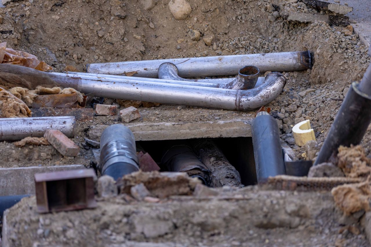 Home Close-up of urban pipe installation at a construction site, showing various pipes and materials.