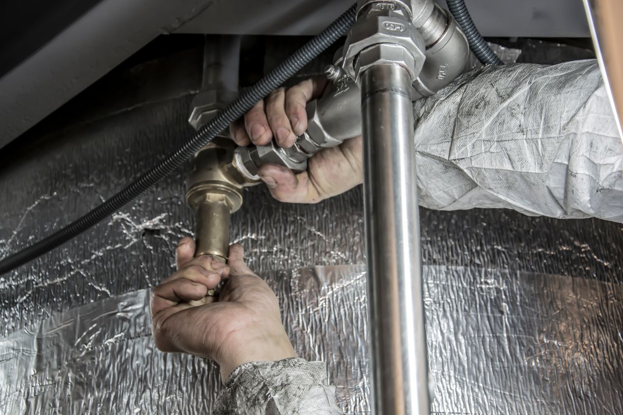 The Art of Drawing Readers In: Your attractive post title goes here Close-up of a plumber's hands installing steel pipes indoors, showcasing skilled manual work.
